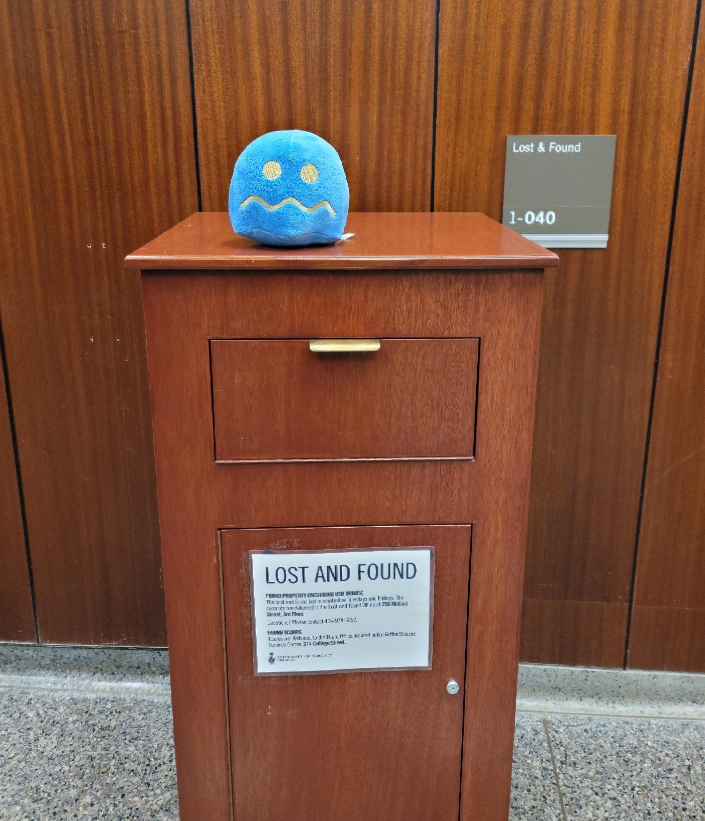 lost and found box with blue plush toy on top