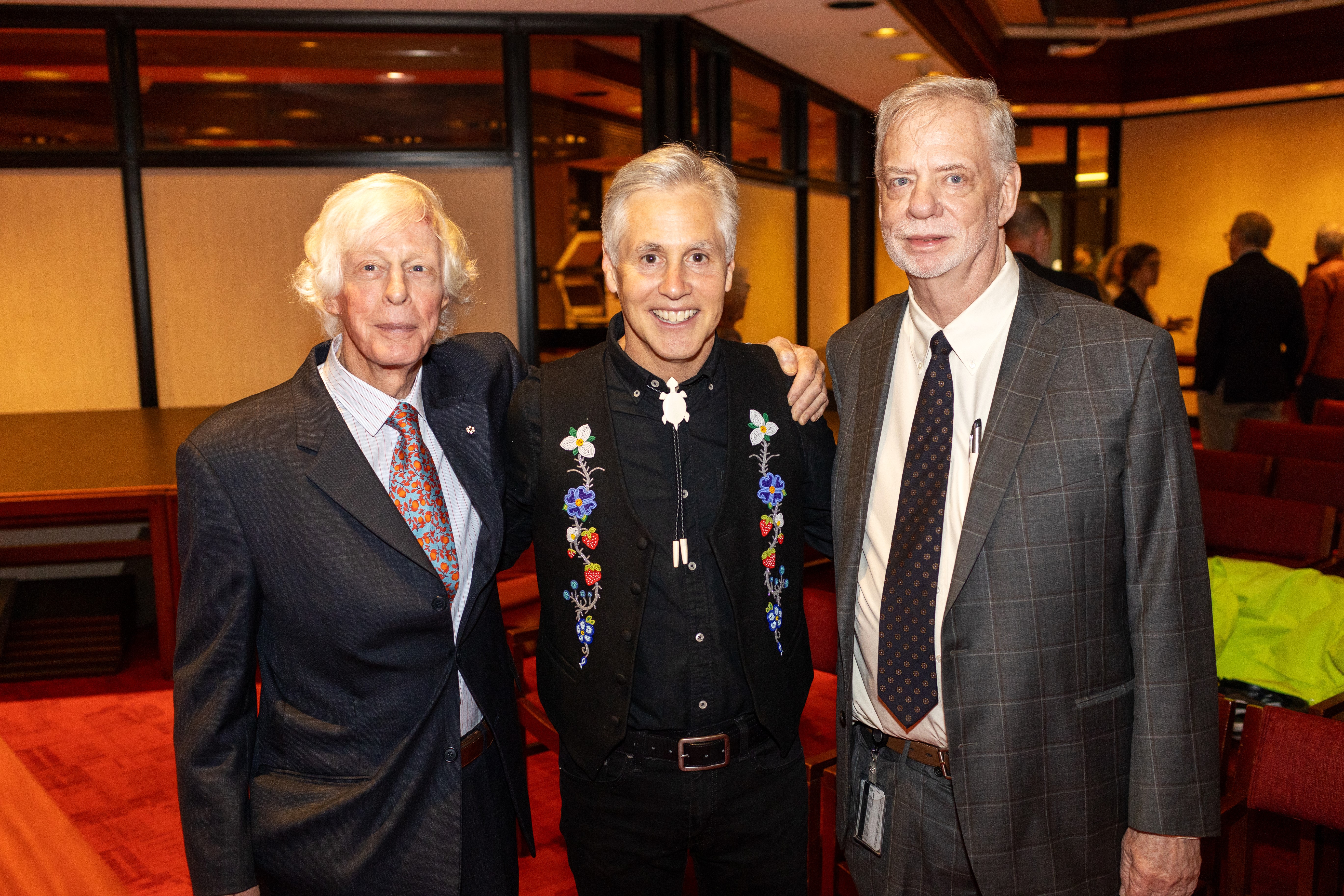 Three men pose in front of a camera during the Chamberlin Lecture Series. Their names are Ted Chamberlin, Professor John Borrows and University Chief Librarian Larry Alford.