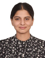 Shoulder up image of Mehakpreet Kaur Saggu, a woman in a black blouse with white flowers, smiling against a white backdrop