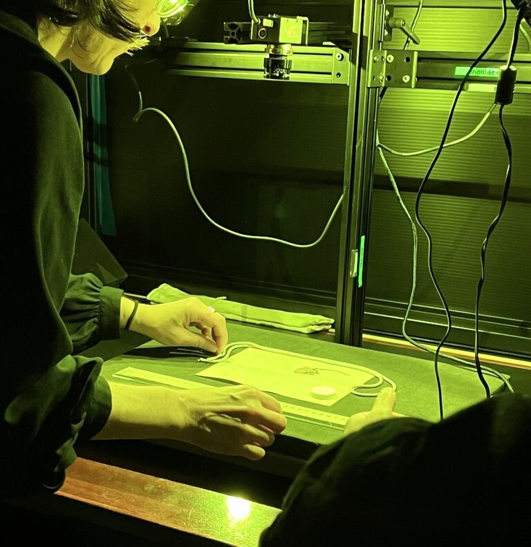 Stephanie J. Lahey, PhD, Andrews Fellow in Book Science at the Old Books New Science Lab  scans a letter using MISHA. 