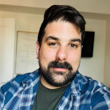 A white man with a beard and plaid shirt