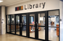 glass doors with a sign that says "UTSC library"